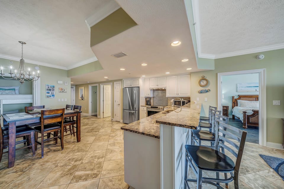 There is a dining table, as well as additional breakfast bar seating.