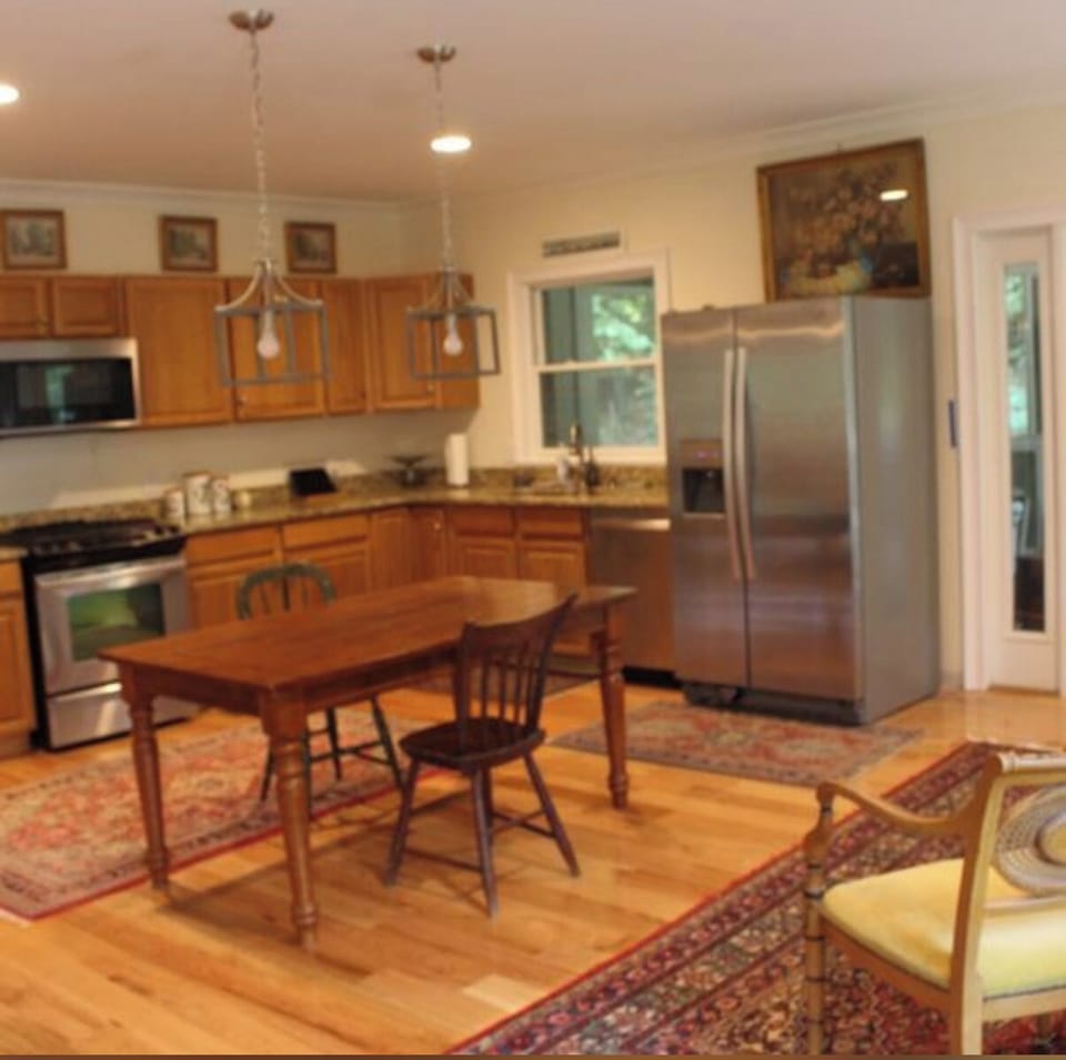 Kitchen opens to screen porch w/ table for 6, & wrap around porch w/ gas grill.