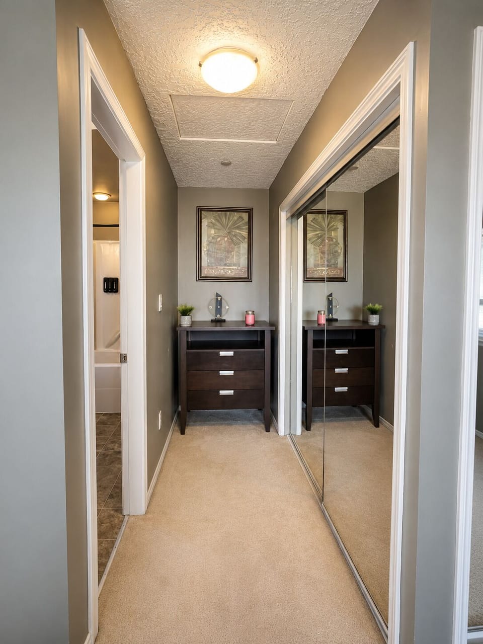 Mirrored closet and dresser offer convenient storage for your belongings.
