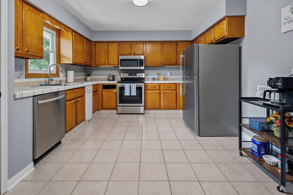 Full kitchen with refrigerator, oven, stove, microwave, and dishwasher