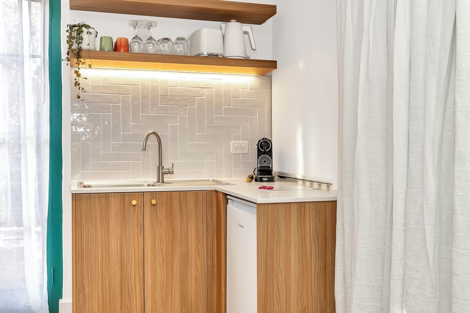 Wet bar in lounge/dining with Nespresso machine and bar fridge.