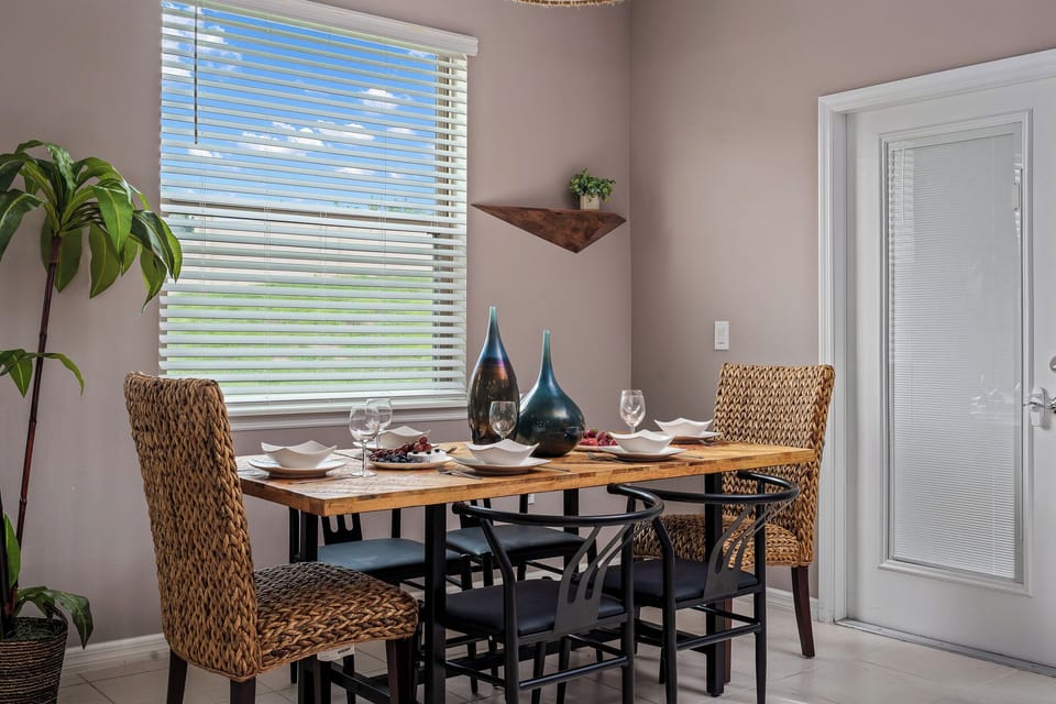 The rustic wooden table paired with comfy black metal chairs seats 6 guests.