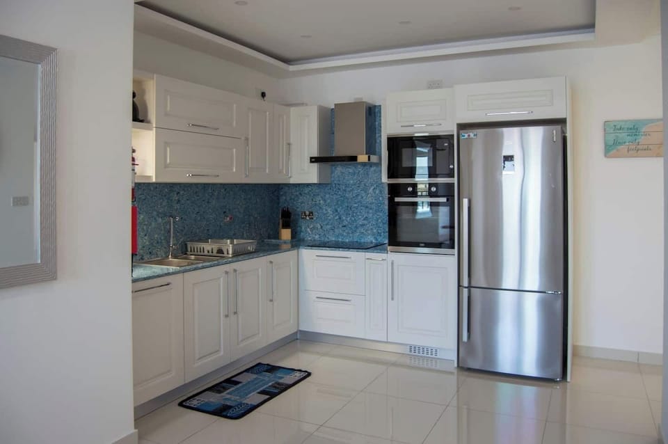 Kitchen with all amenities. Electric kettle, dishwasher, microwave, induction hob, oven, fridge and freezer. Well equipped with everything you may need.