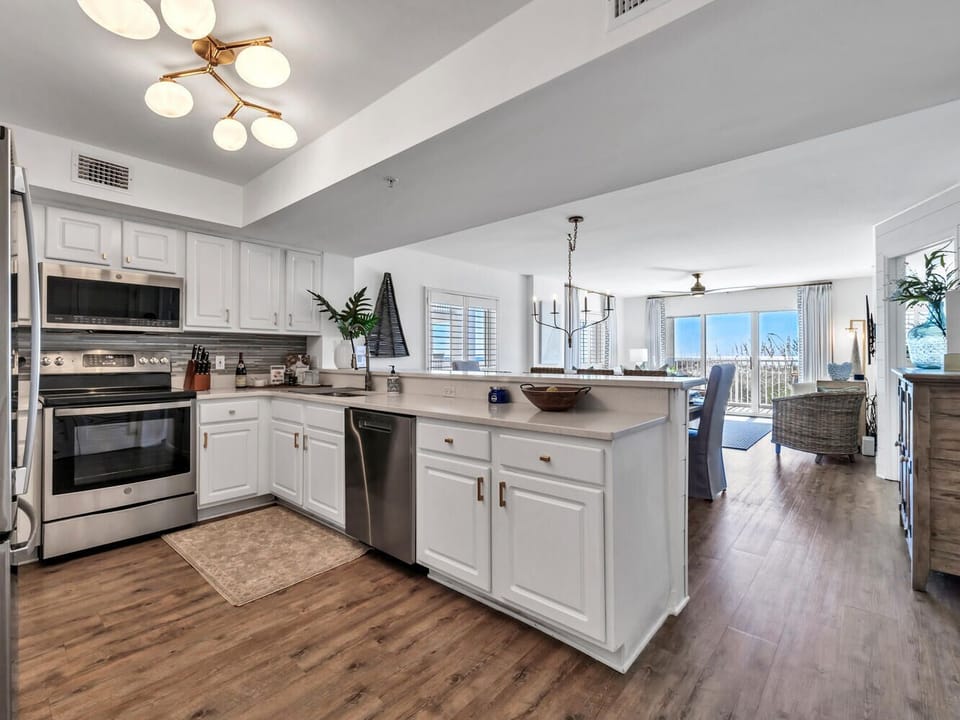Your modern kitchen flows seamlessly into the living space, featuring stainless appliances and a breakfast bar for morning coffee or casual meals.
