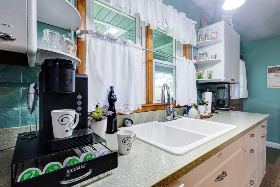 Bright vintage-style kitchen with sunny windows and guest-ready coffee station