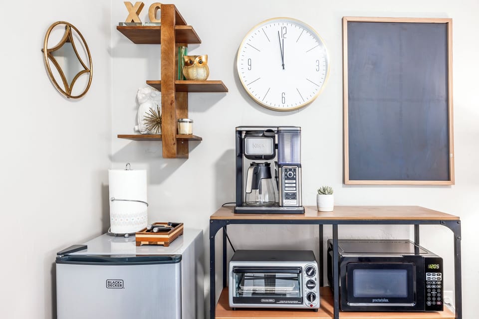 Coffee maker, toaster oven, microwave, and dishes.