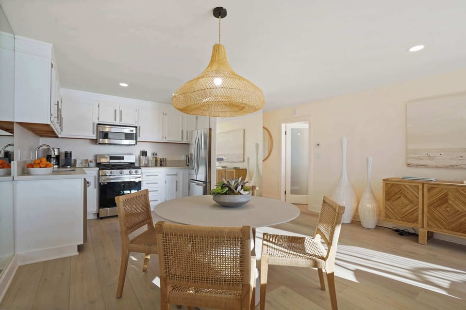 Gather around the dining table, where chic design meets the warmth of natural light.