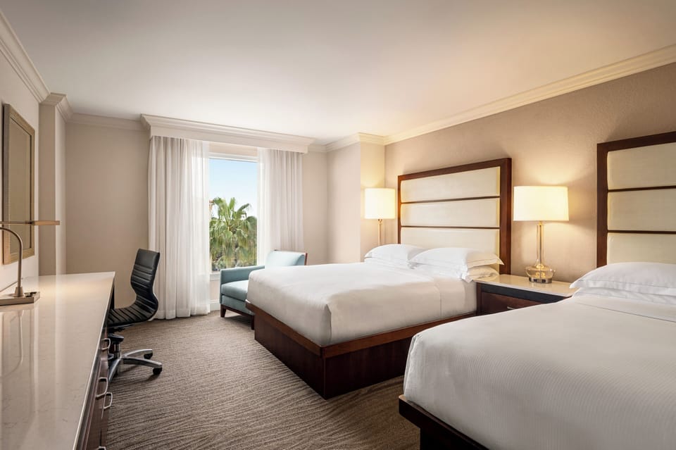 Unwind in crisp linens with calming daylight and space.