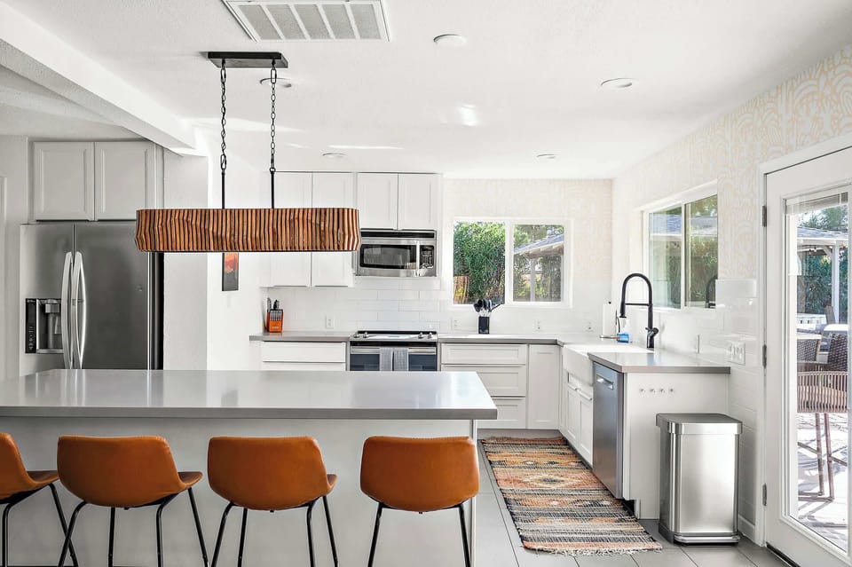 Savor every moment! Our fully stocked kitchen invites you to whip up meals with a view and easy access to the outdoors