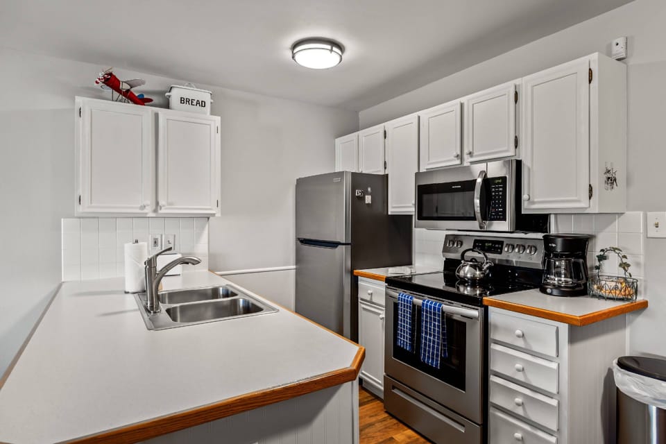 Sunny open kitchen with full amenities—cook, chat, and entertain in a bright, welcoming space that brings everyone together.
