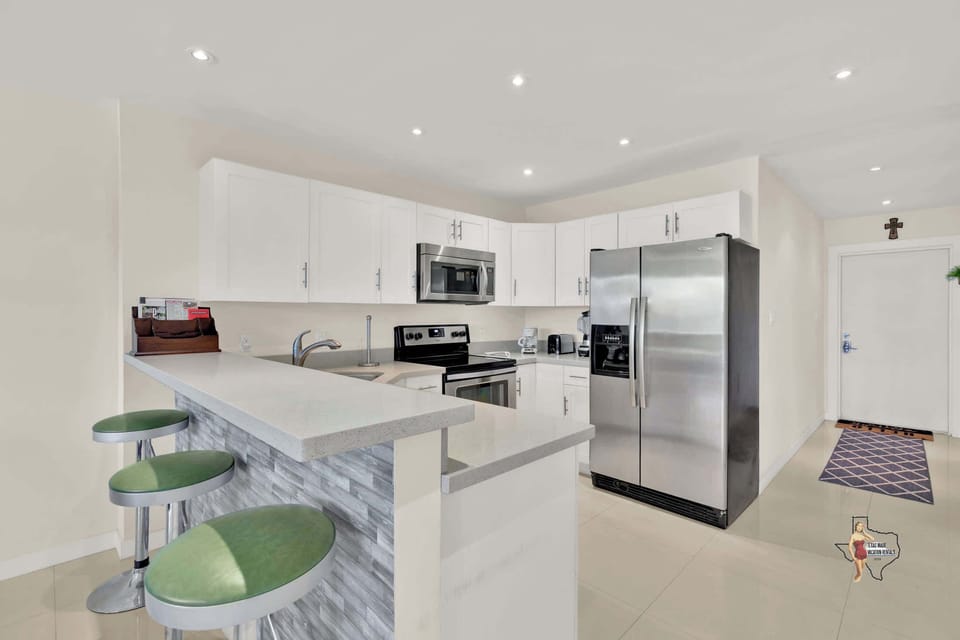 There’s a convenient breakfast bar with three bar stools for a quick snack