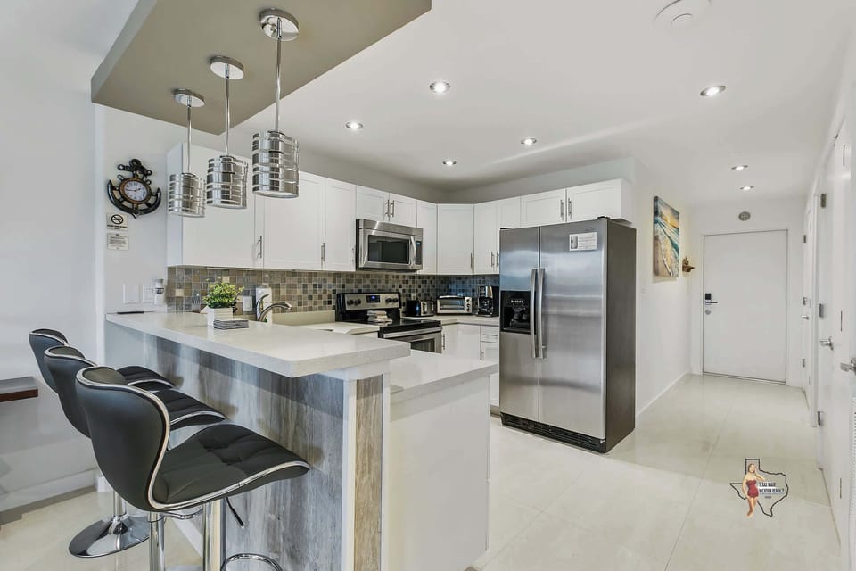 There’s a convenient breakfast bar with three cushioned bar stools