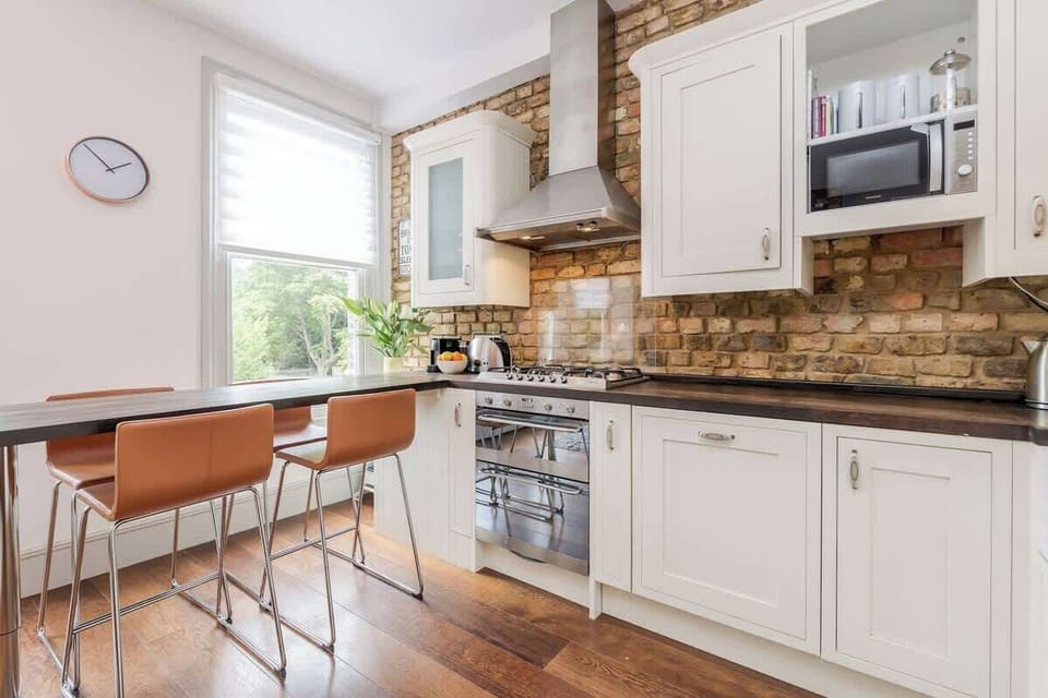 Kitchen is fully equipped and with modern appliances. It has a wooden breakfast bar where you can enjoy your meals and socialise