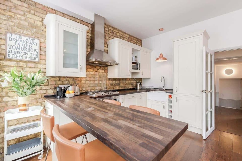 Kitchen is fully equipped and with modern appliances. It has a wooden breakfast bar where you can enjoy your meals and socialise