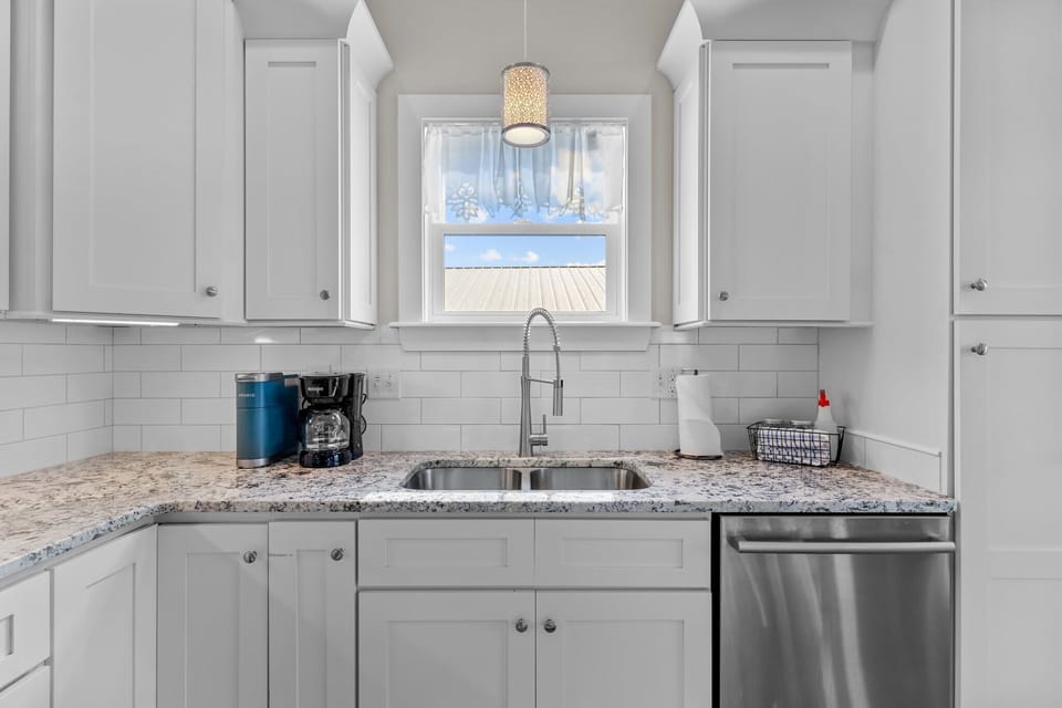 Modern White Kitchen w/ Breakfast Bar Seating, Stainless Steel Appliances, Refrigerator, Oven, Stovetop, Microwave, Refrigerator, and Much More