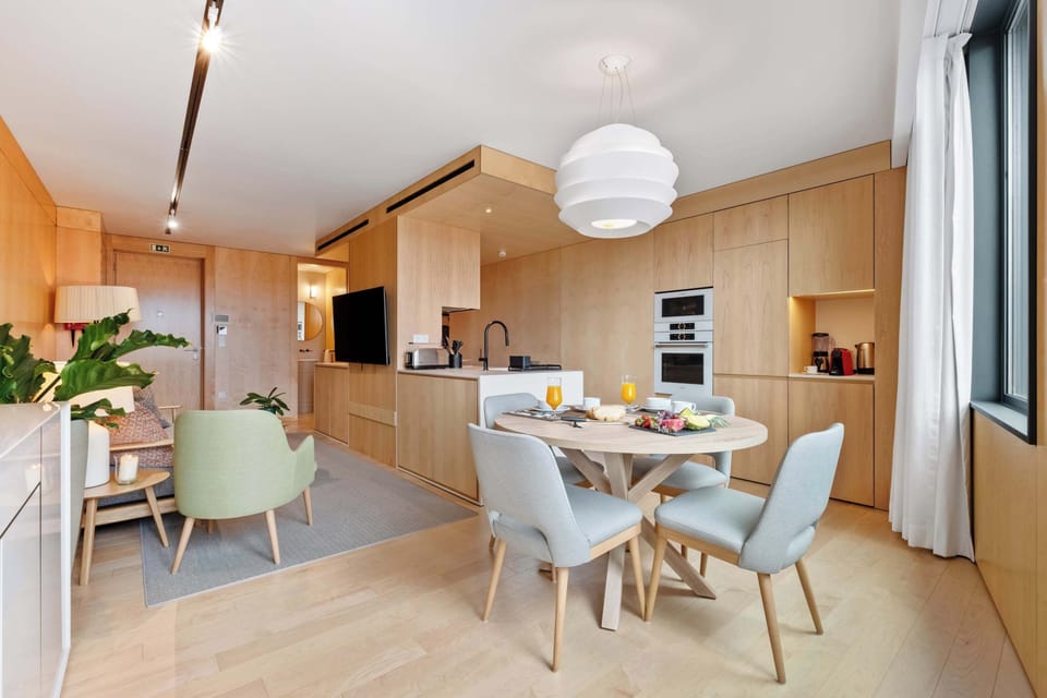 Our living area includes a comfortable dining table, a full kitchen and the sofa bed and TV