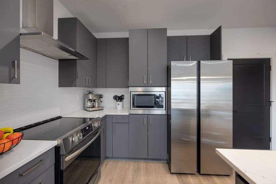 The sleek, open kitchen offers ample space & every home comfort