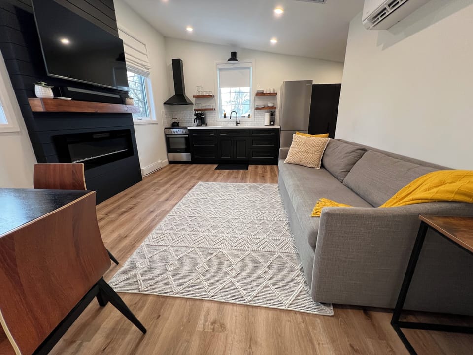 Open concept living and kitchen space with queen sofa bed.