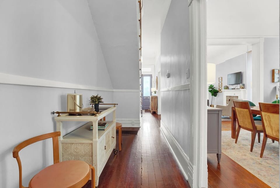 A hallway on the first floor connects the main foyer to the sitting room, dining room, and kitchen.
