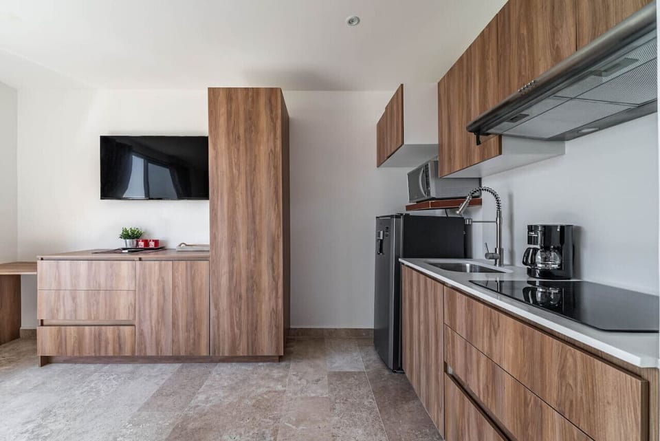 A well-designed kitchenette with essential appliances and utensils for your convenience.
