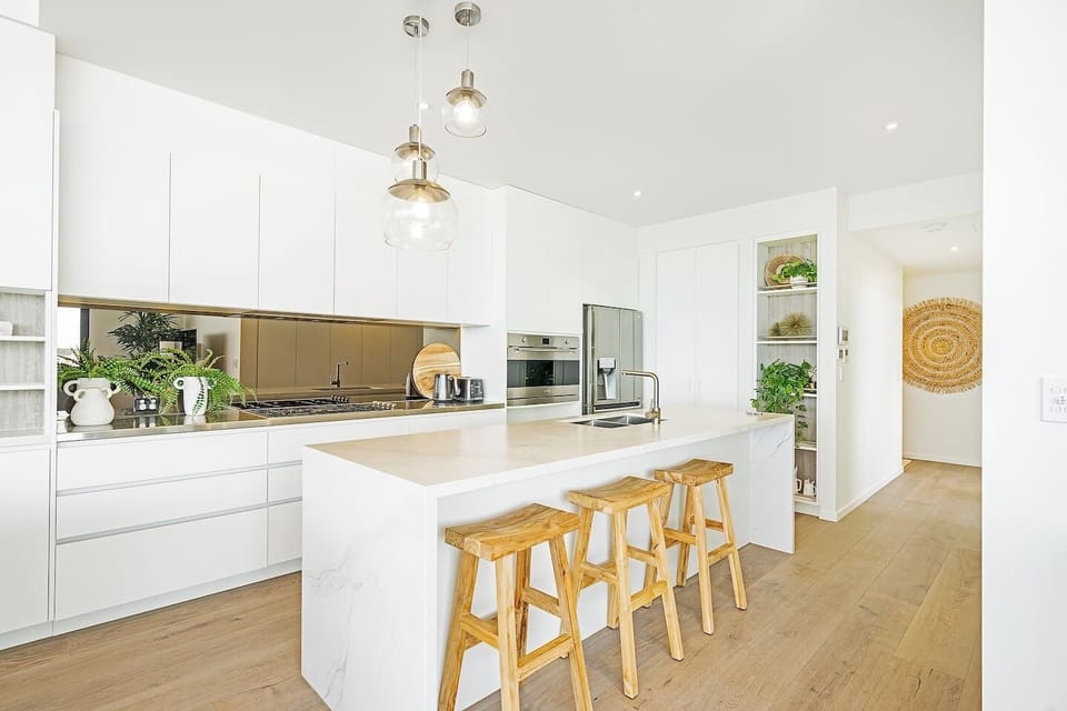 The gourmet kitchen is designed around a centre island bench, where you can prepare meals, socialise or enjoy slow mornings at home.
