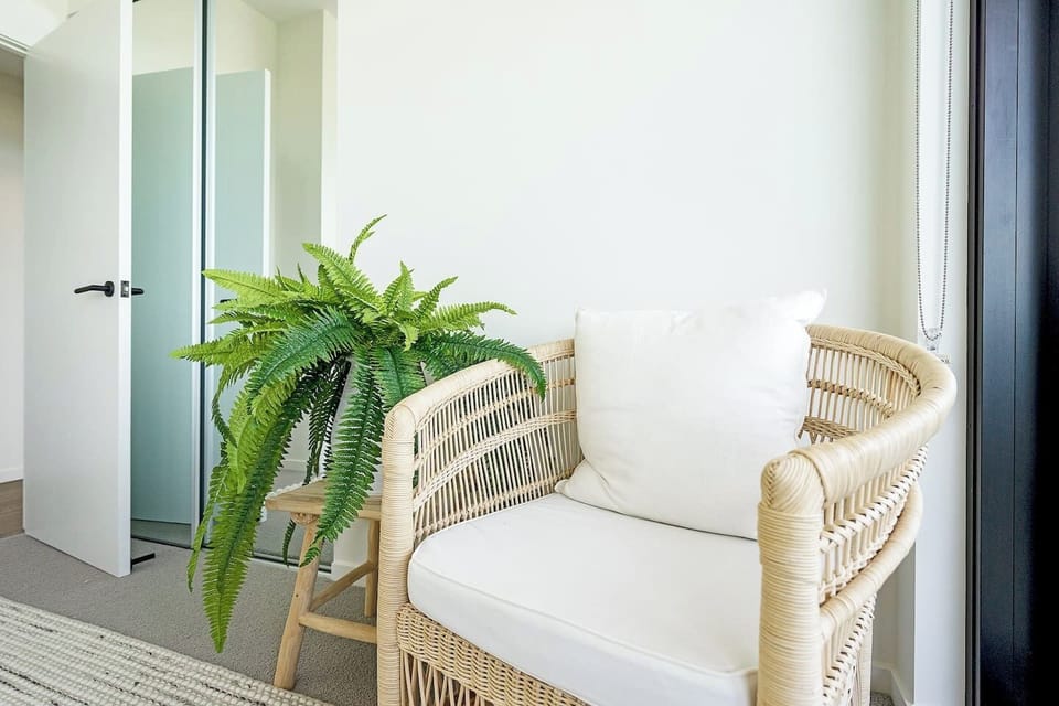 A wicker reading chair invites you to cosy up with your favourite book to the sound of crashing waves.