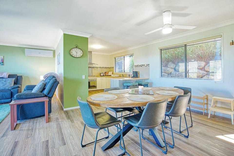 Alongside the living area, you’ll find a stunning timber dining table that can fit up to six guests
