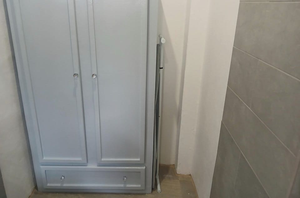 The wardrobe has hanging area with multi- storey  storage shelves and one drawer 