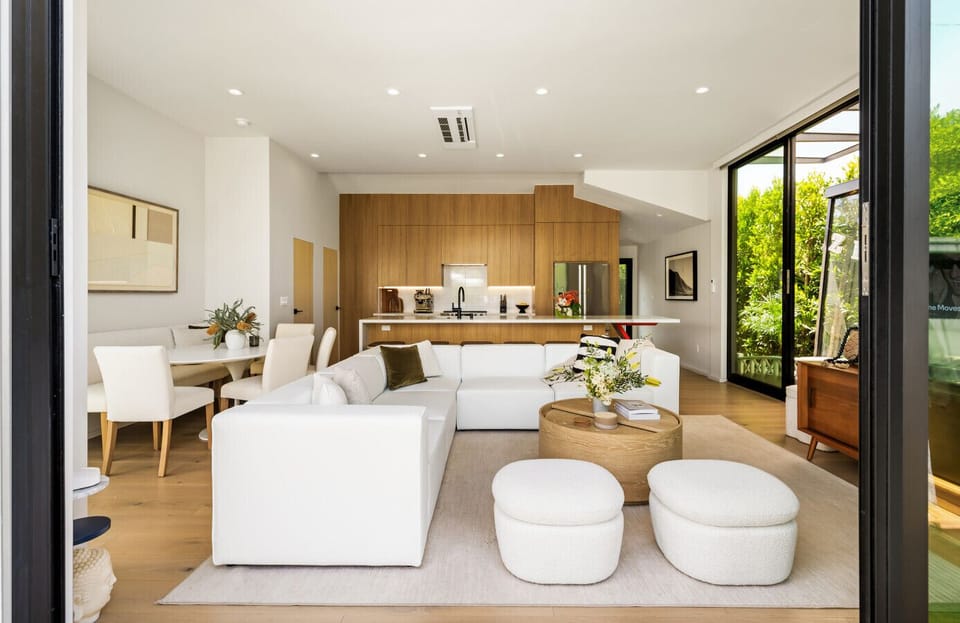 Step into a bright and airy living room bathed in natural light—perfect for relaxing or gathering with loved ones. Featuring a plush sofa, entertainment setup, and thoughtful design touches for your comfort and enjoyment.