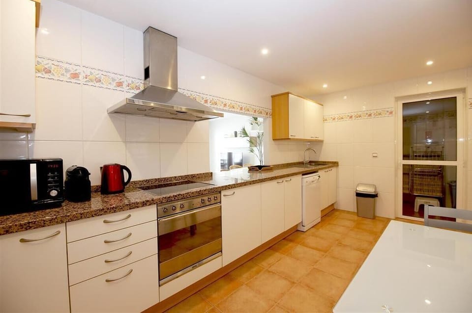 Another view of the kitchen with laundry room to the rear