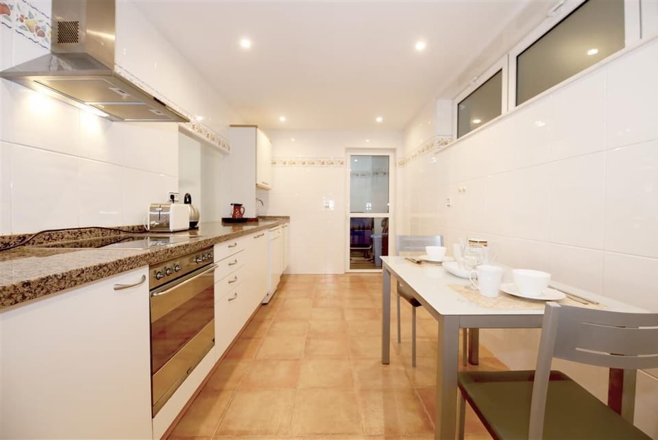 Huge kitchen is fully equipped and has a laundry room to the rear