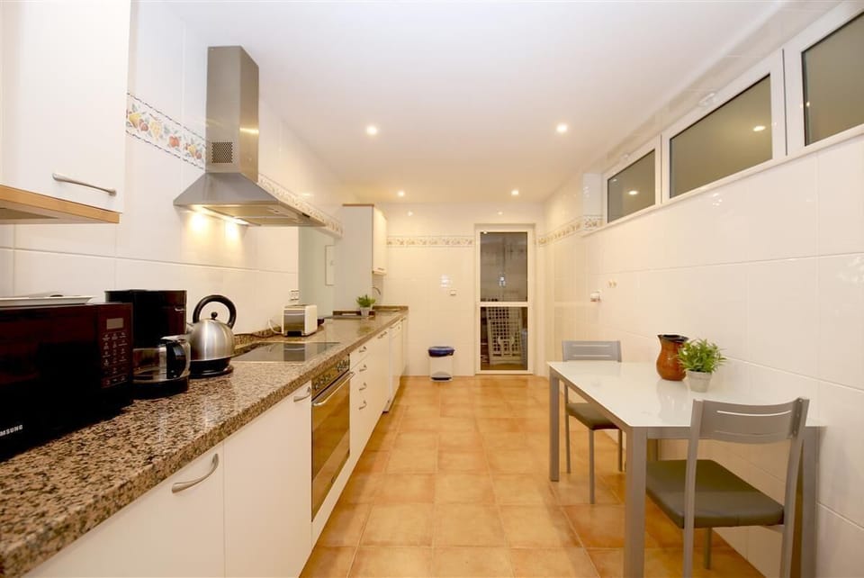 Spacious kitchen is fully fitted and has a laundry room to the rear
