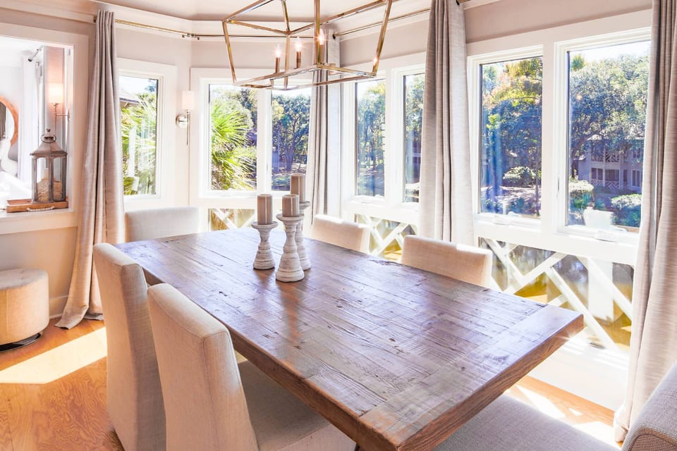 There are stunning views of the lagoon from the wall of windows near the dining table.