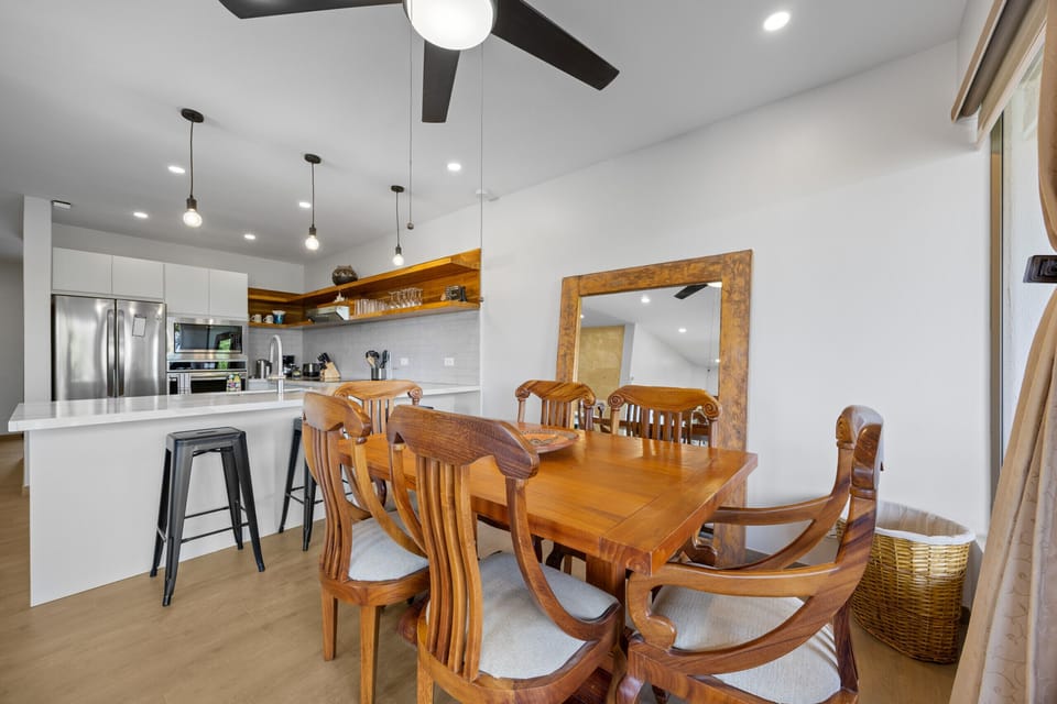 Experience a cozy dining area with ocean views and a rustic wood table