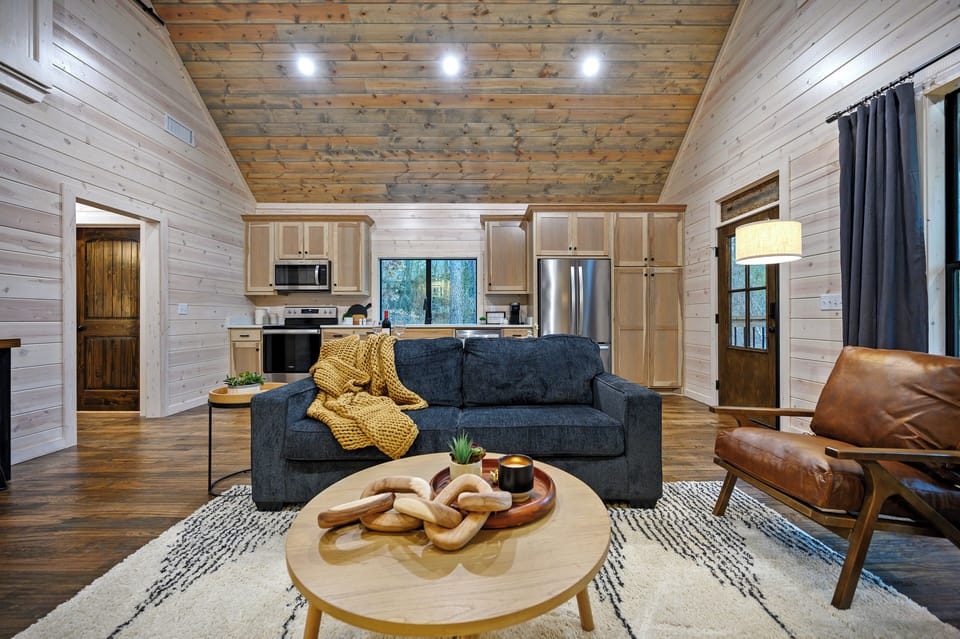 Enjoy the cozy comfort of Early Bird's living room, complete with a plush couch and a modern, fully-equipped kitchen—perfect for relaxing and cooking after a day of adventure.