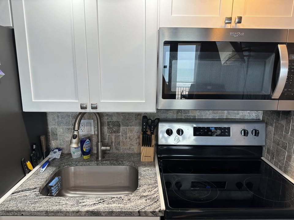 Full stove/oven, sink and full size refrigerator