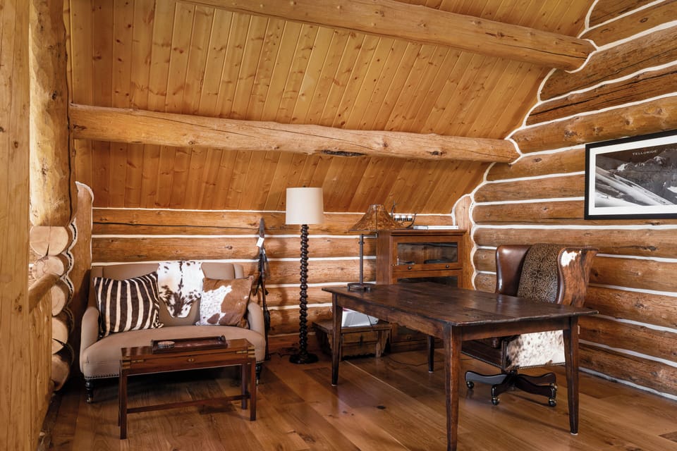 Upstairs reading area by primary suite with high ceilings, mountain views and work desk