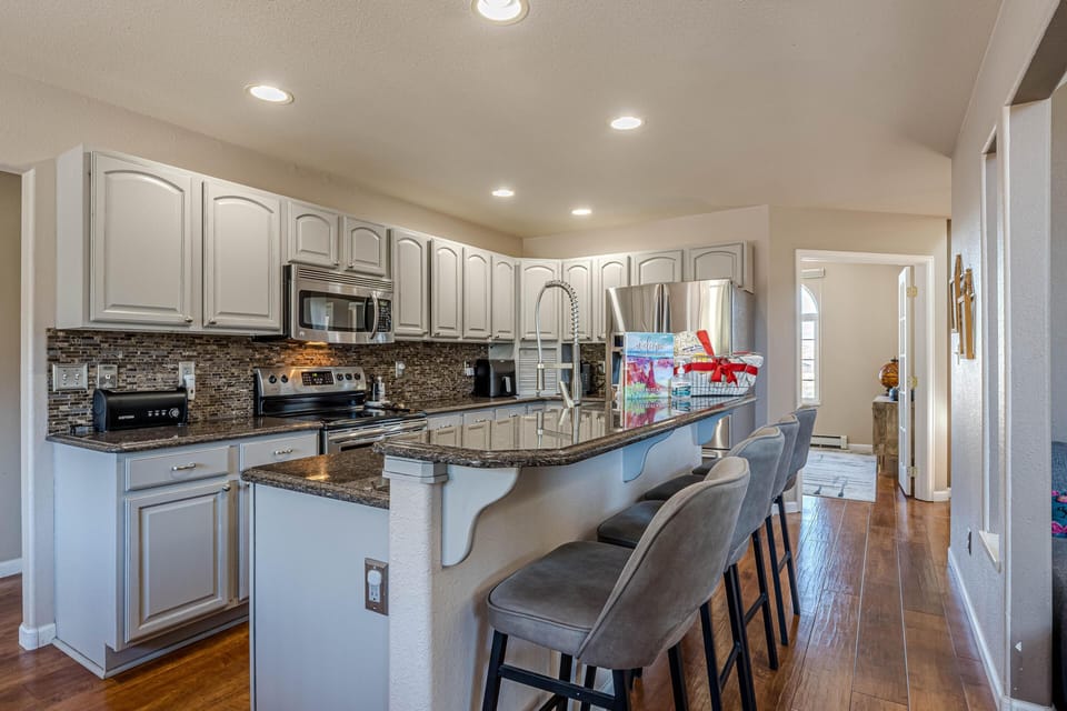 Gather around the elegant island, where plush barstool seating invites you to sip, savor, and socialize in total comfort.