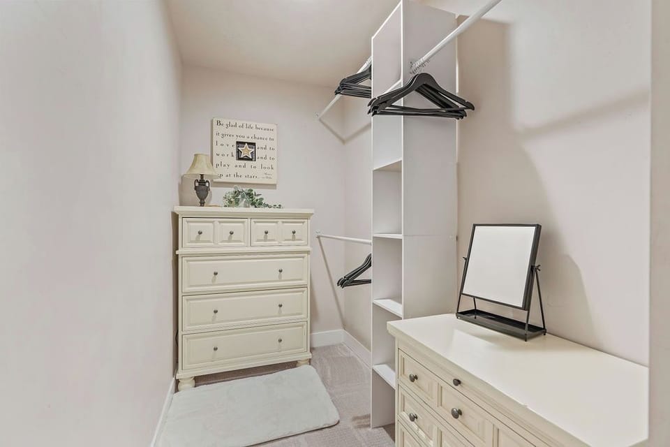 Master closet with plenty of storage, iron and ironing board