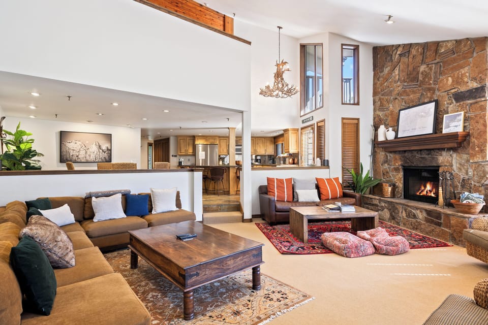 - Open living space with fireplace and lodge style decor  
- Comfortable sofas and rustic details for cozy gatherings  
- Connected layout with kitchen and dining for group stays
