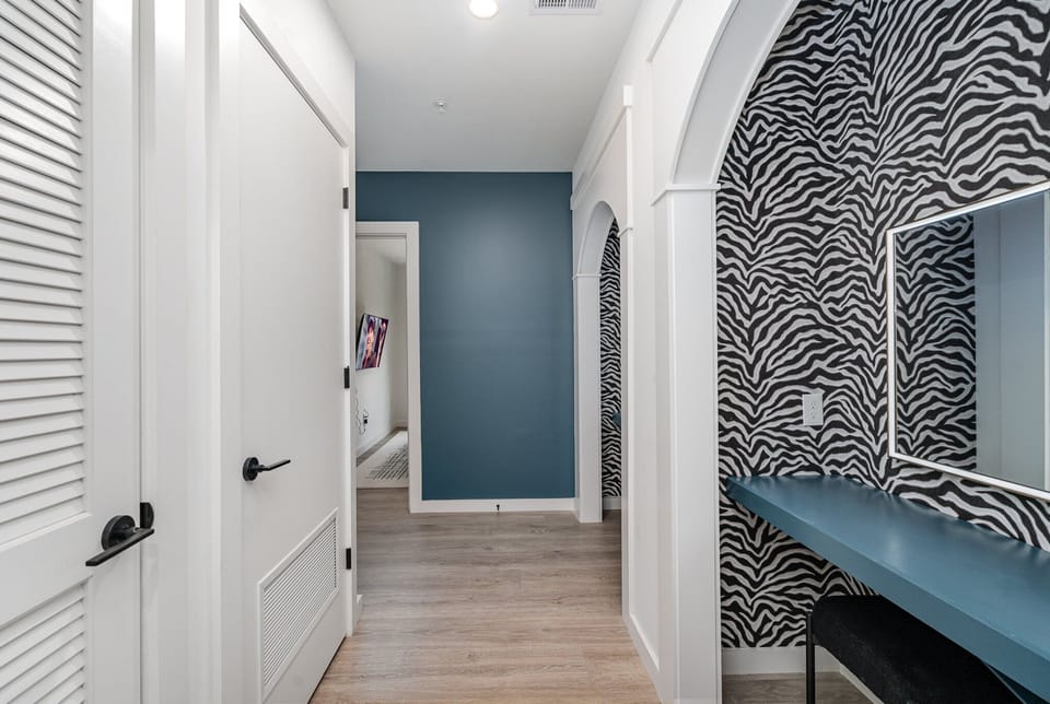 Unit 1: 2 Get-Ready Vanities each featuring 2 chairs and a mirror next to the living space.