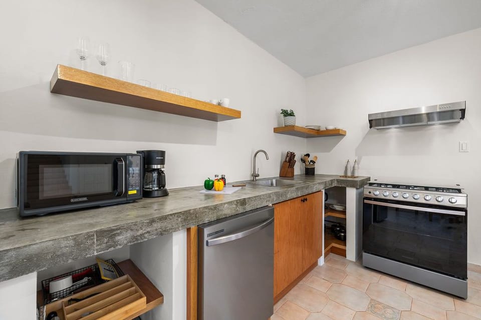 The ample counter space provides plenty of room for meal prep, while the stylish cabinetry offers convenient storage for your kitchen essentials