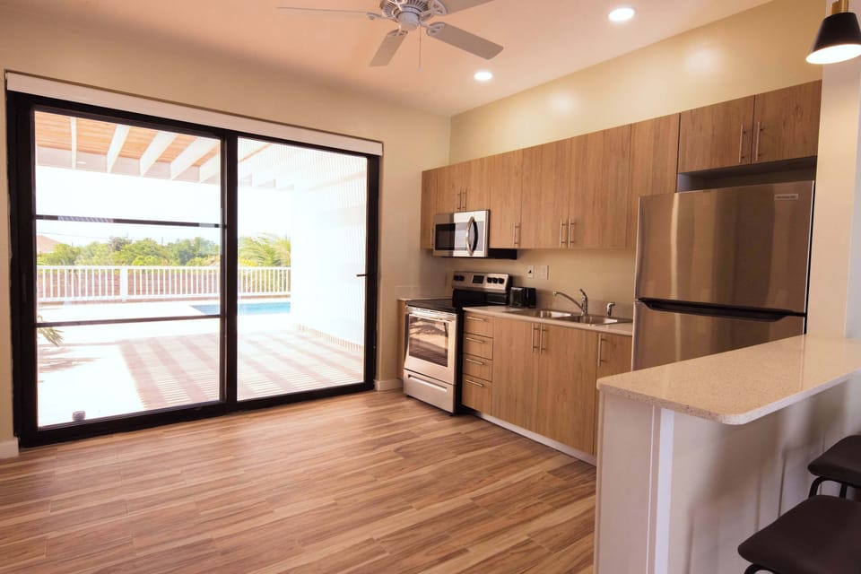 Direct access to the pool area is through the kitchen