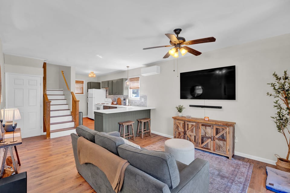 Relax and unwind in the cozy living room, featuring comfortable seating and serene lake views.

