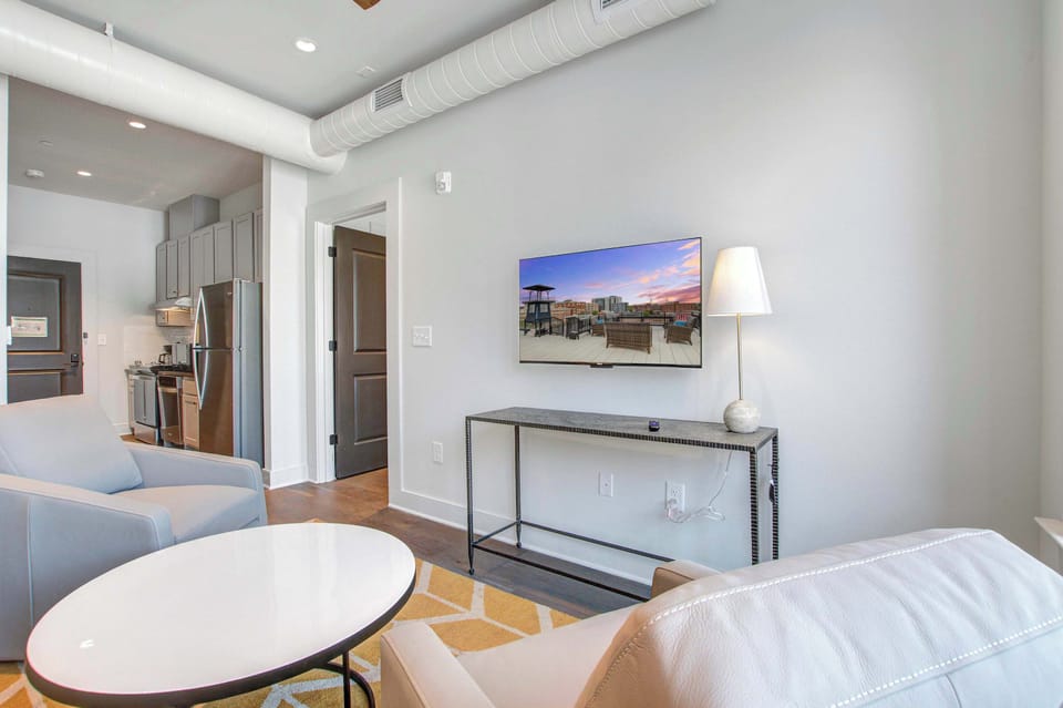 Professionally designed living room space with a Smart TV! Please note there is no balcony but plenty of shared outdoor seating space. 