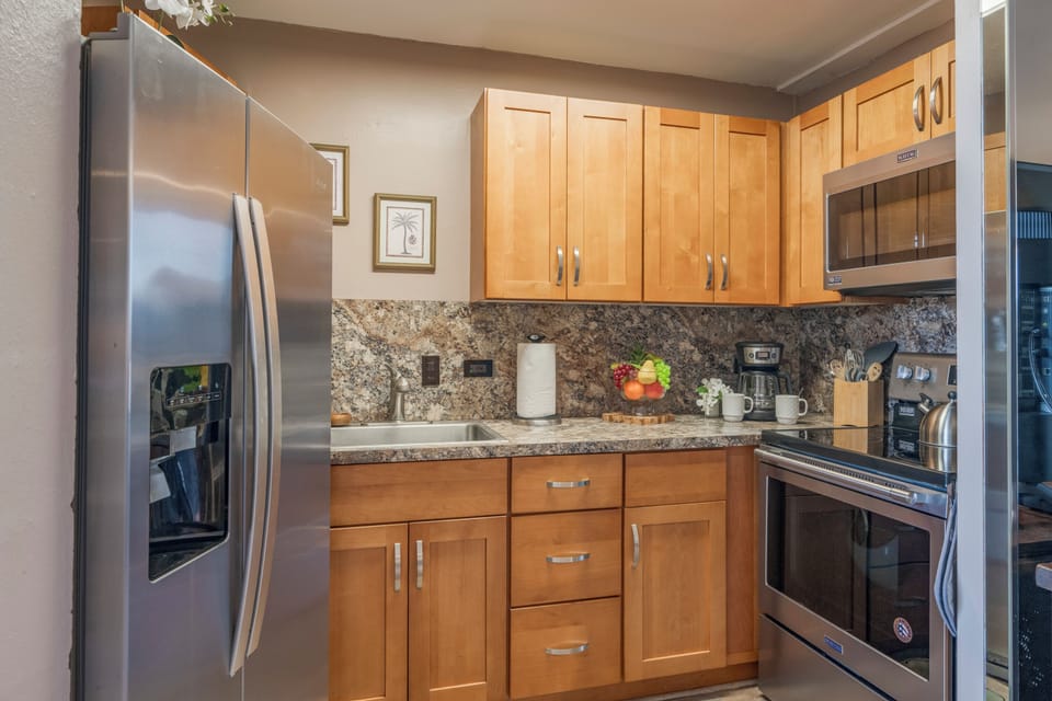 This modern kitchen features stainless steel appliances, granite countertops, and plenty of cabinet space. Perfect for cooking up your favorite meals.