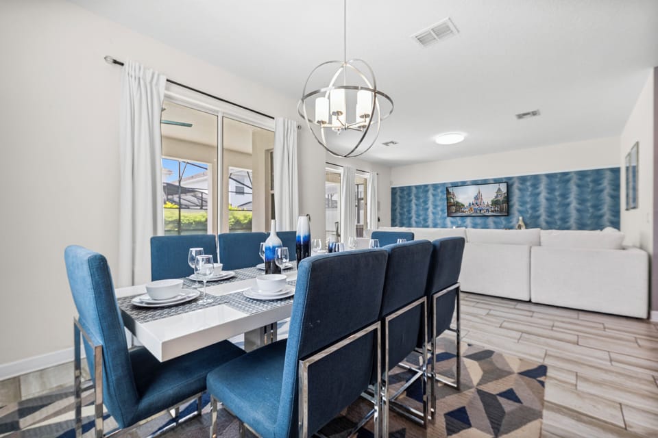 - Gather around a chic dining table that seats eight for memorable meals - Bright and airy dining space, perfect for family dinners or celebrations - Convenient access to the outdoor patio and pool area.