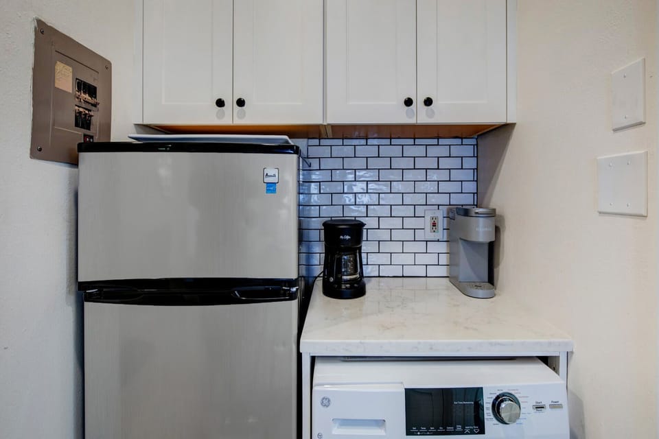 Your kitchenette comes fully equipped with stainless steel appliances, subway tile backsplash, and a Keurig for your morning coffee, making meal prep and snacks effortless during your stay.
