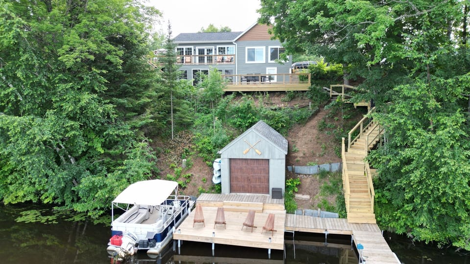 A serene dock with cozy chairs, right by the lake! Enjoy peaceful moments or launch a kayak from the shed for a fun adventure. 