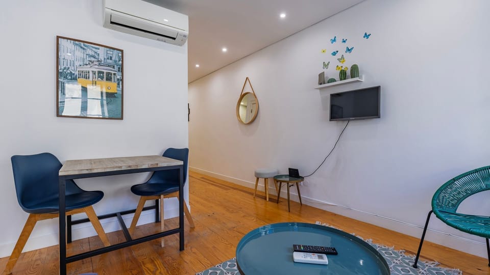 The lounge area features playful decor, a cozy TV nook, and natural light streaming through large windows. #BrightSpaces #RelaxInStyle